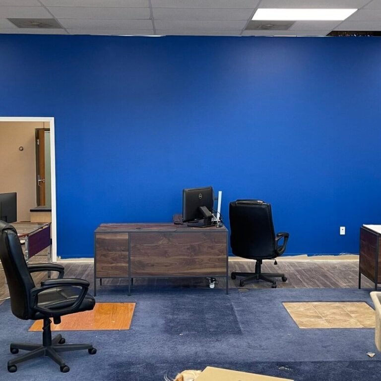 Office with a blue accent wall, desks, and chairs