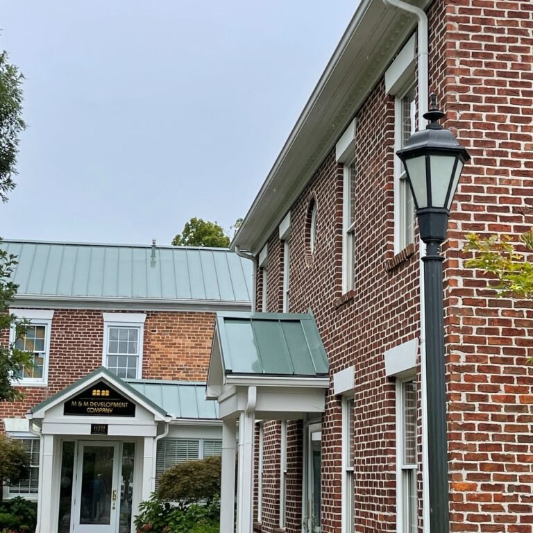 Brick building with white porch and trim
