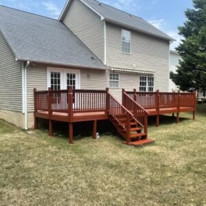 Stained wooden deck beside a house